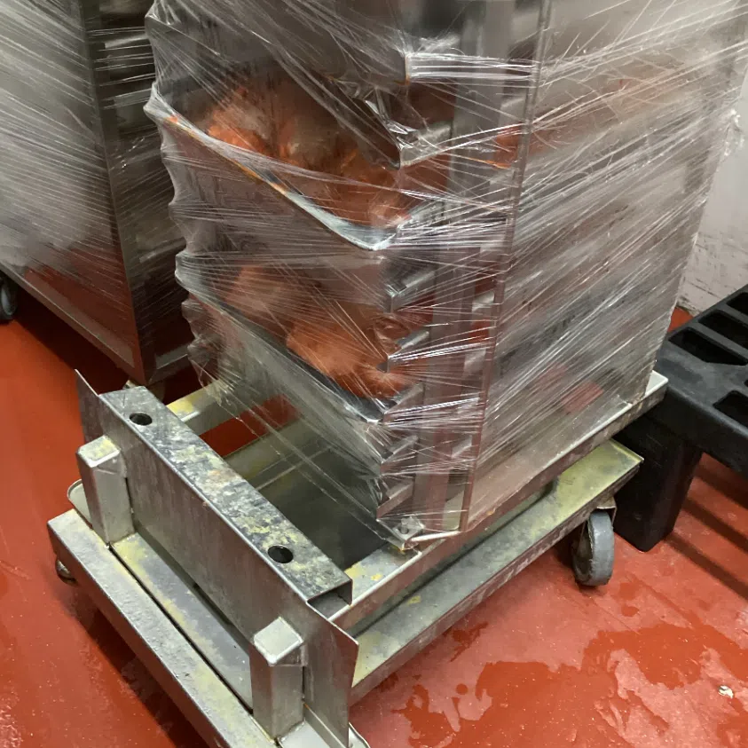 A dirty food trolley (left) and dirty racks in Gourmetz's central kitchen.