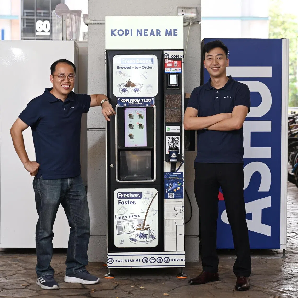 (From left) Loh Jian Yuan, 40, and Leow Jun Heng, 27, co-founders of Kopi Near Me with one of the local start-up’s vending machines at Ubi Techpark which serves up freshly brewed Nanyang-style coffee.