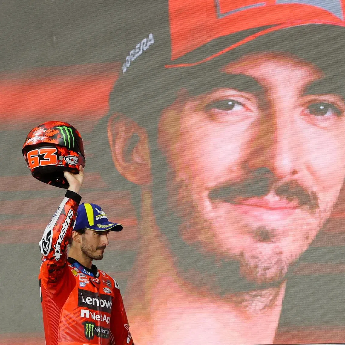 MotoGP - Qatar Grand Prix - Lusail International Circuit, Doha, Qatar - April 13, 2025 Ducati Lenovo Team's Francesco Bagnaia celebrates on the podium after finishing third in the Qatar Grand Prix REUTERS/Ibraheem Al Omari