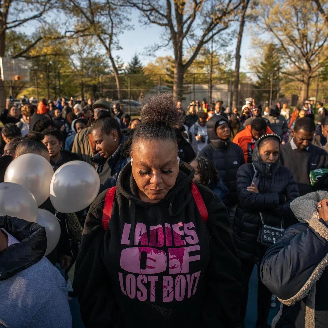 Mourners gather around a temporary memorial for a community vigil to remember Jaden Pierre, shot at a basketball court on Thursday, in New York, April 20.
