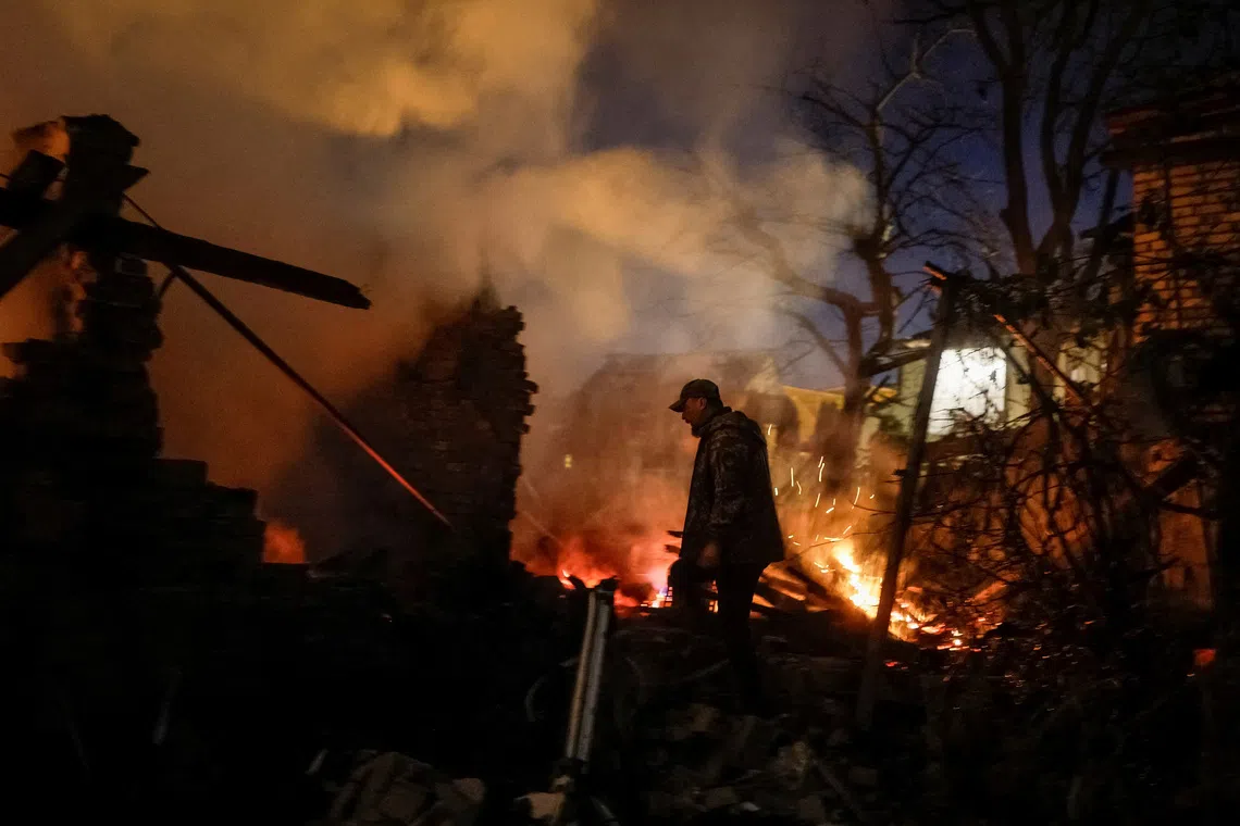 A Ukrainian serviceman, Oleh, looks for his wife, Yevheniia, and her mother at the site of their private house hit by a Russian drone strike, amid Russia's attack on Ukraine, in Kyiv, Ukraine, September 30, 2026. REUTERS/Gleb Garanich TPX IMAGES OF THE DAY