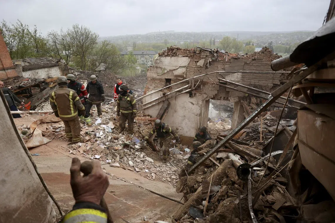 Ukrainian rescuers remove debris after a rocket attack on the local history museum in the city of Kupiansk, Ukraine, on April 25.