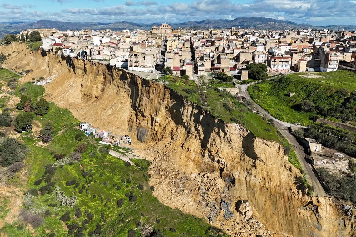 A drone picture shows houses perched along the edge of a cliff after a landslide in Niscemi, Sicily, Italy, January 27, 2026. REUTERS/Danilo Arnone