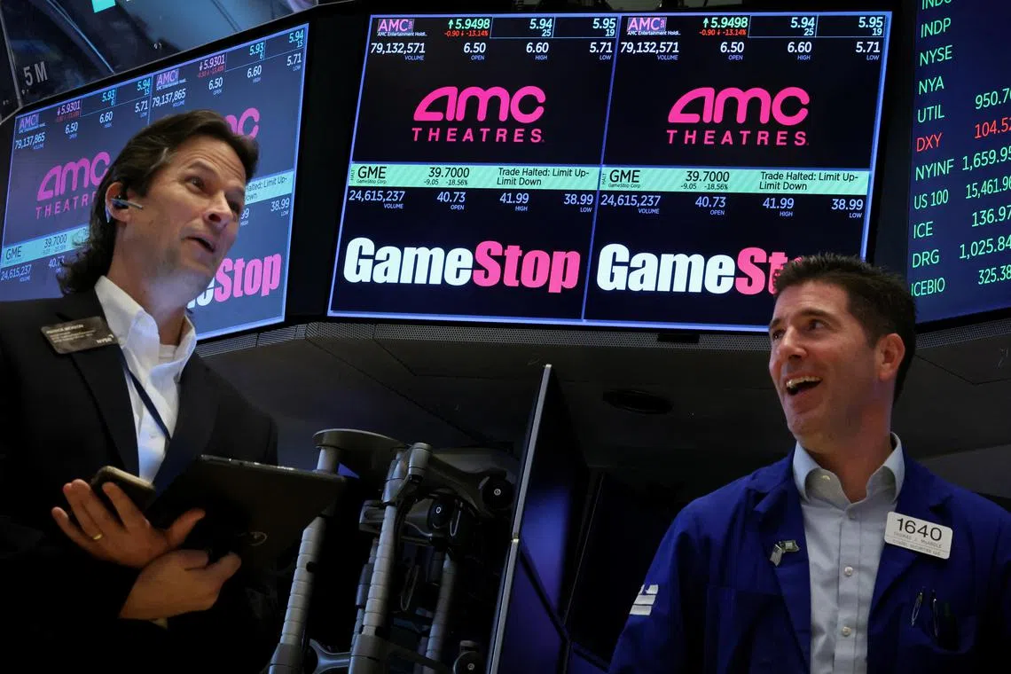 Traders work as a screen displays the trading information for GameStop and AMC Theatres on the floor at the New York Stock Exchange (NYSE) in New York City, U.S., May 15, 2024.  REUTERS/Brendan McDermid     
