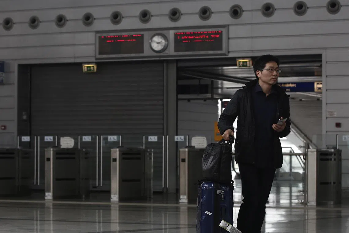 epa10502591 A commuter walks past the closed entrance to a suburban train station during a 48-hour strike announced by railway unions against the conditions of the country's railway network, days after a deadly train crash, at the Eleftherios Venizelos international Airport in Athens, Greece, 04 March 2023. At least 57 people died following a head-on crash between two trains along the Athens-Thessaloniki line on the night of 28 February.  EPA-EFE/YANNIS KOLESIDIS
