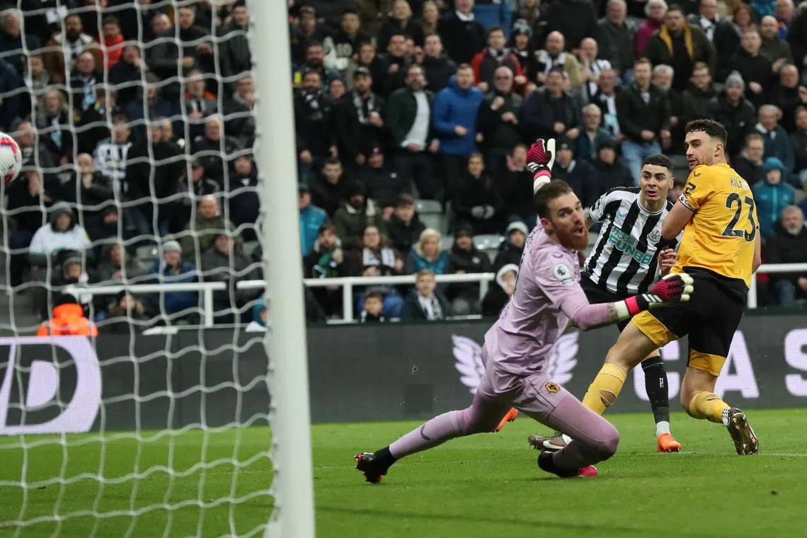 Newcastle United's Miguel Almiron scores their second goal past Wolverhampton Wanderers' Jose Sa.