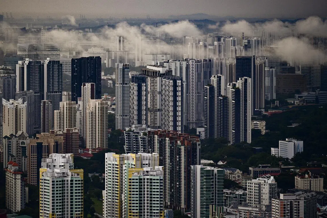 Rain clouds over condominiums and HDB flats as viewed from the Sky Garden of CapitaSpring on Mar 2, 2022.