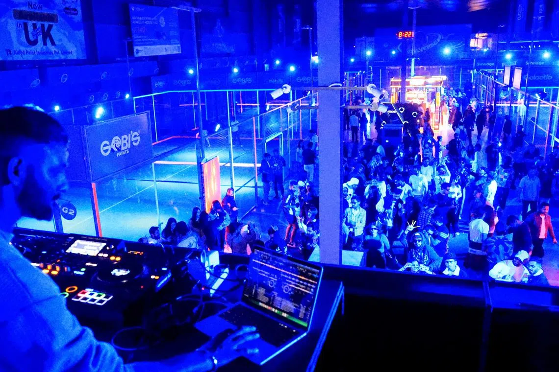 Sagar Naik, known as DJ Sagar, plays at a neon padel party organised by 12xperience, at Padelverse in Karachi, Pakistan, November 29, 2025. REUTERS/Akhtar Soomro