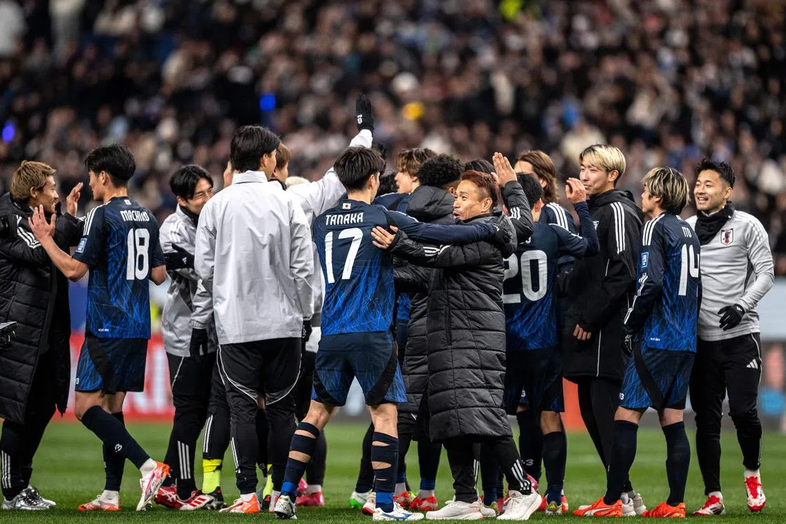 Team Japan celebrates after winning the 2026 FIFA World Cup Asian qualification football match between Japan and Bahrain in Saitama on March 20, 2025. (Photo by Philip FONG / AFP)