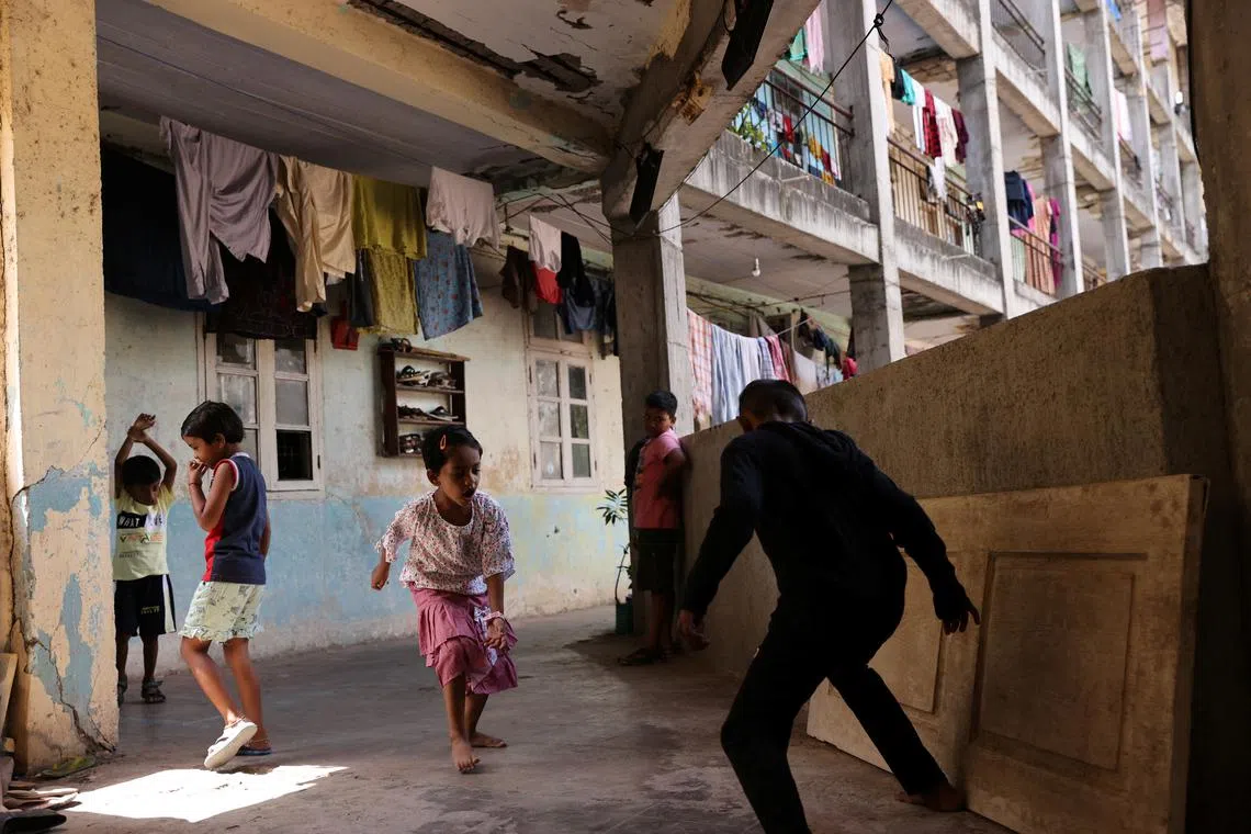 Children playing in the corridor at the Worli dairy quarters building in Mumbai, India, March 30, 2023.