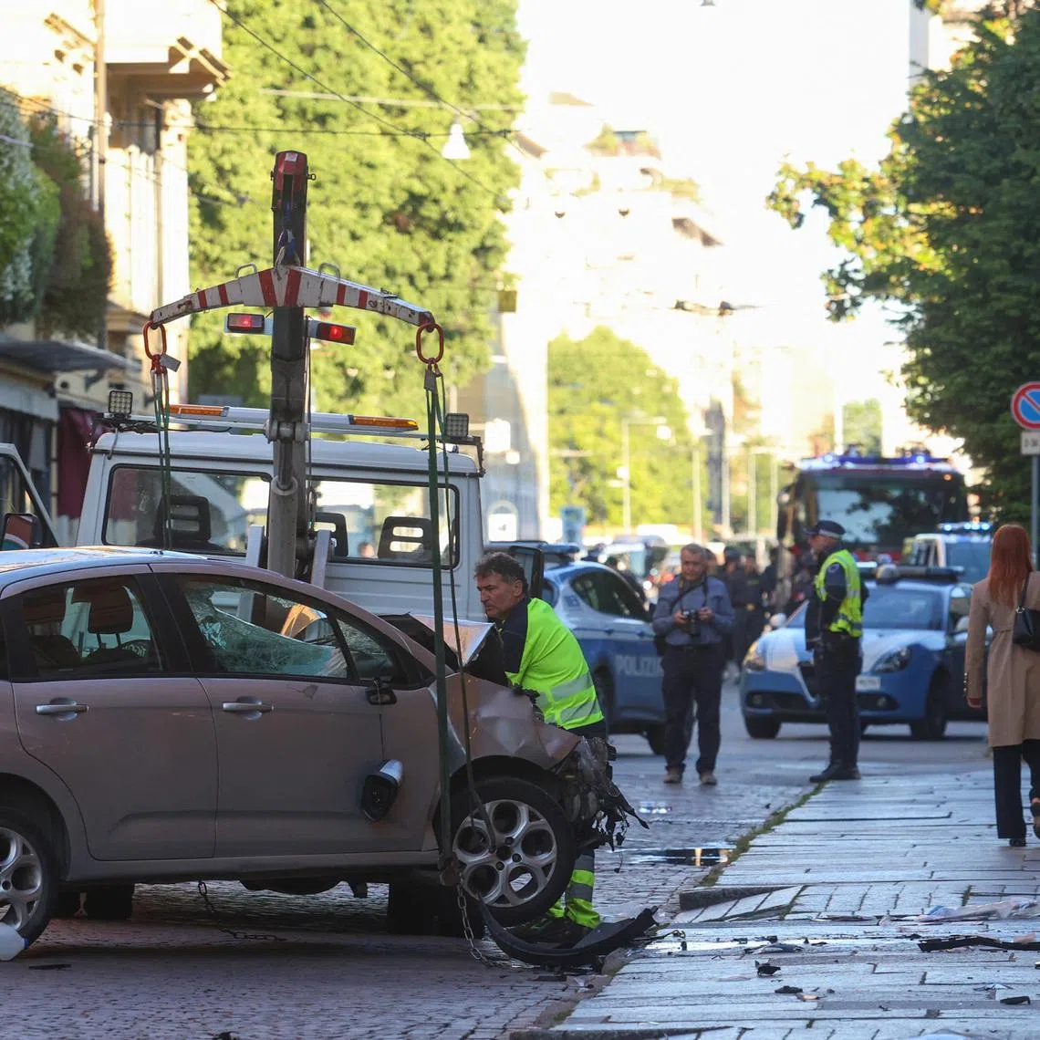 The car that drove into pedestrians is removed from the scene after several people were injured in the center of the northern Italian city of Modena, Italy, May 16, 2026. REUTERS/Stringer