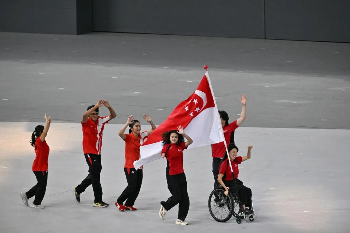 The Singapore flag swept into the stadium, carried by Team Singapore athletes and para-athletes.