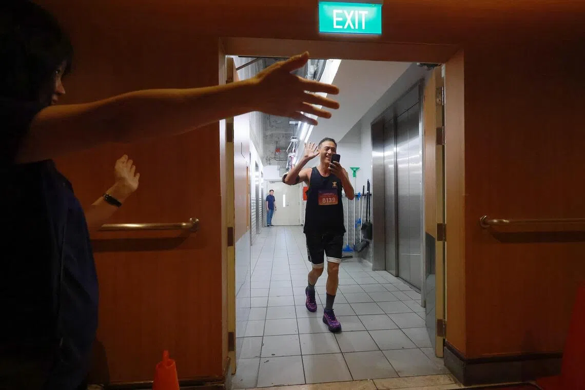 A participant celebrates as he rounds a corner on floor 57 towards the finish line.