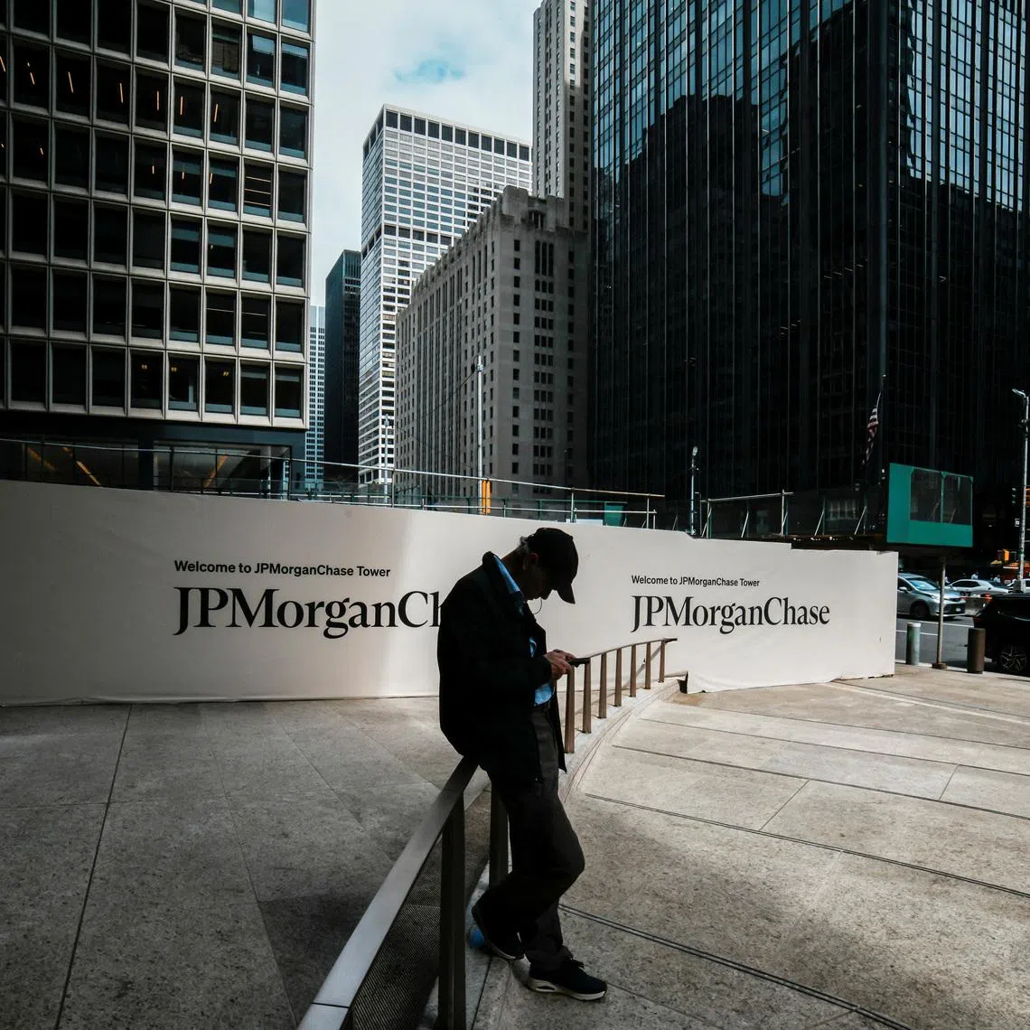 A person waits near one of the entrances of the JPMorgan Chase & Co., headquarters in New York City, U.S., April 1, 2026. REUTERS/Eduardo Munoz/File Photo