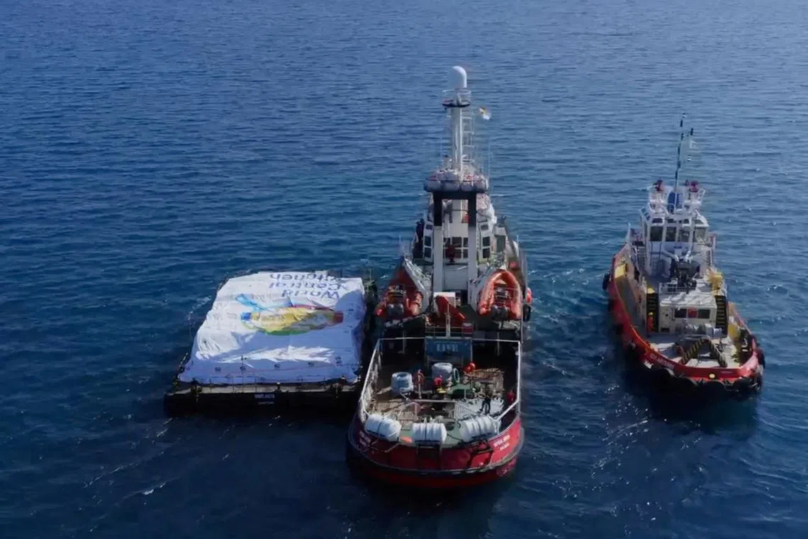 Aid ship sails, amidst a test to launch a new sea route from a port in Cyprus to deliver aid to residents of the Gaza Strip who are on the brink of famine, at sea, March 12, 2024, in this screen grab from a handout video.  World Central Kitchen/Handout via REUTERS