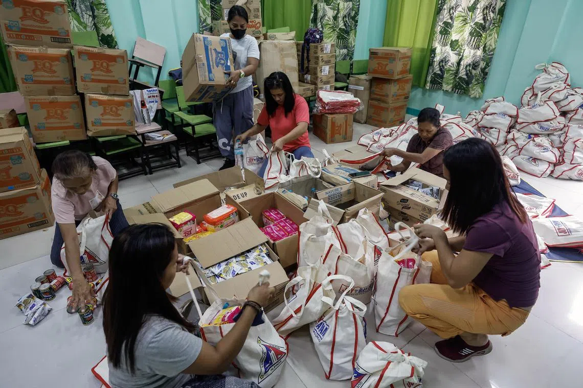 epa10656881 Village welfare staff and volunteers pack bags of relief goods prepared for possible typhoon evacuees in Quezon City, Metro Manila, Philippines, 27 May 2023. Evacuation centers are on alert and relief goods are prepared by local government units in Metro Manila communities as the Philippines weather bureau tracks the movement of typhoon Mawar. Typhoon Mawar is estimated to be 1,170 kilometers east of the central Luzon region of the Philippines, with maximum winds of 195 kilometers per hour.  EPA-EFE/ROLEX DELA PENA