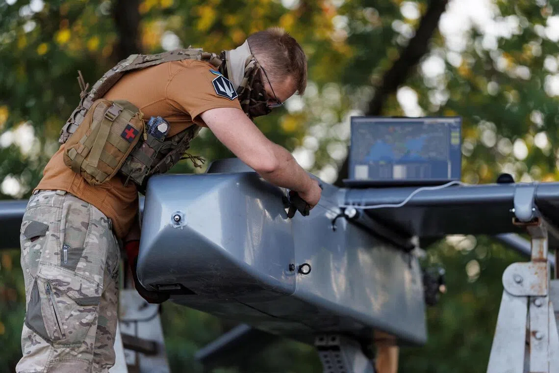 A service member of the 414th Separate Unmanned Strike Aviation System Brigade Magyar’s Birds’ of the Ukrainian Armed Forces prepares an FP-1 deep-strike drone for a combat mission, amid Russia’s attack on Ukraine, in an undisclosed location in Ukraine, in 2026.