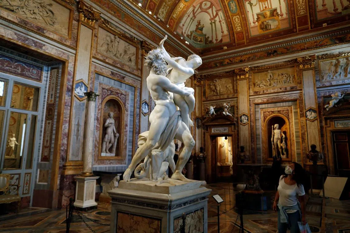 FILE PHOTO: A visitor looks at a statue inside Galleria Borghese, in Rome, Italy, May 22, 2020. REUTERS/Yara Nardi/File Photo