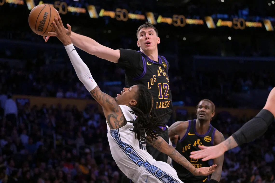 Los Angeles Lakers forward Jake Laravia blocks a shot by Memphis Grizzlies guard Ja Morant in the first half at Crypto.com Arena.