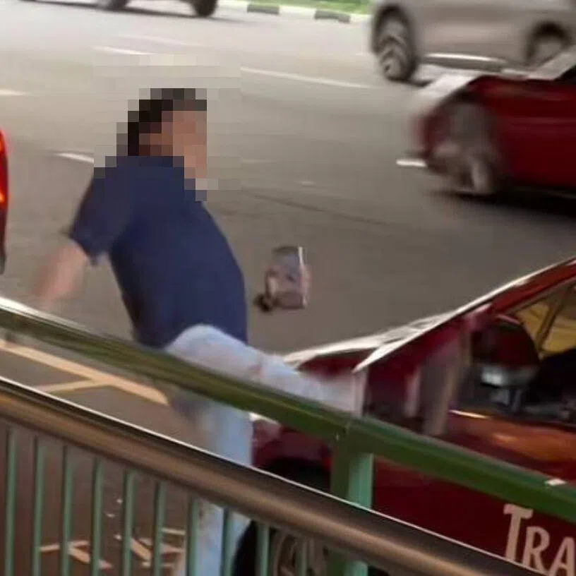At one point in the video, the man in blue kicks the left rearview mirror of the taxi, breaking it and leaving it dangling from the side of the vehicle.