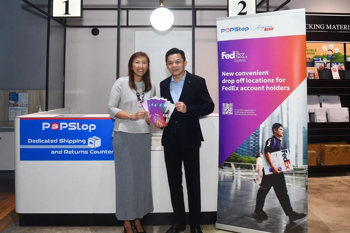 SingPost's Singapore chief executive Neo Su Yin (left) and FedEx Express Singapore's managing director, Eric Tan.