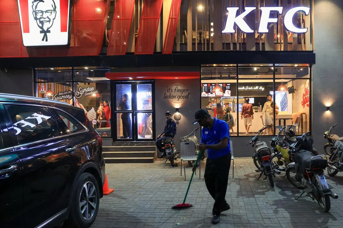 A worker clears the floor at a KFC fast food outlet, which was attacked and vandalised during an anti-Israel protest last week, in Karachi, Pakistan April 17, 2025. REUTERS/Akhtar Soomro
