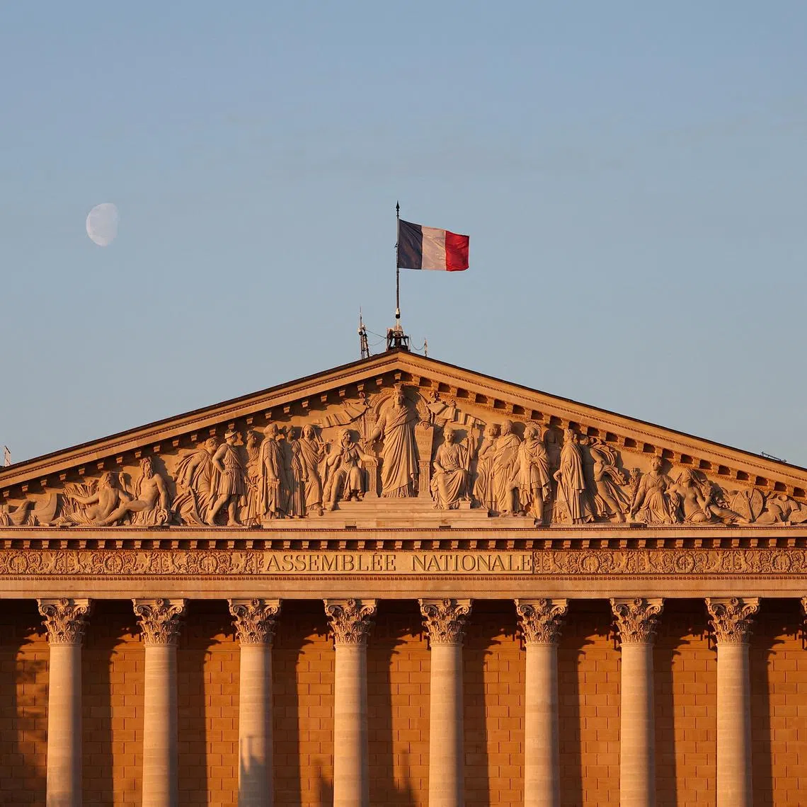 FILE PHOTO: A French flag flies over the National Assembly in Paris, France, April 18, 2025. REUTERS/Abdul Saboor/File Photo