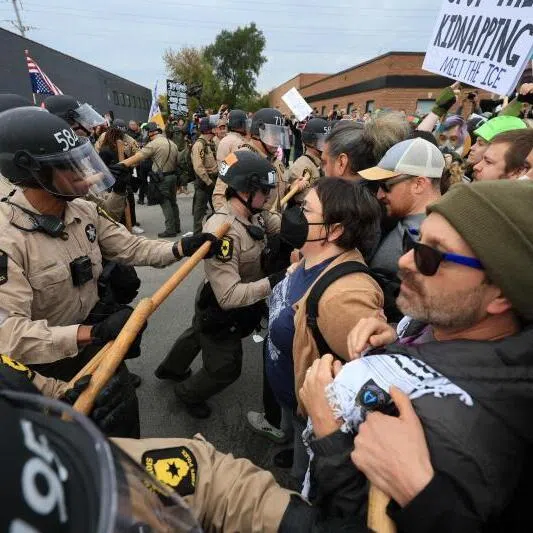 Police clash with demonstrators in the street outside of the "Free Speech Zone" near the immigrant processing and detention centre on Oct 17 in Broadview, Illinois, USA.