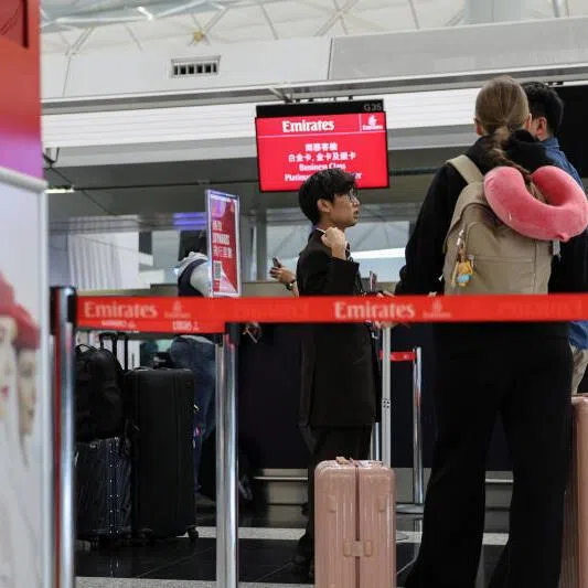 Emirates Airlines passengers inquire about cancelled flight to Dubai at the check-in counter at Hong Kong International Airport, in Hong Kong, China, on March 2, 2026.
