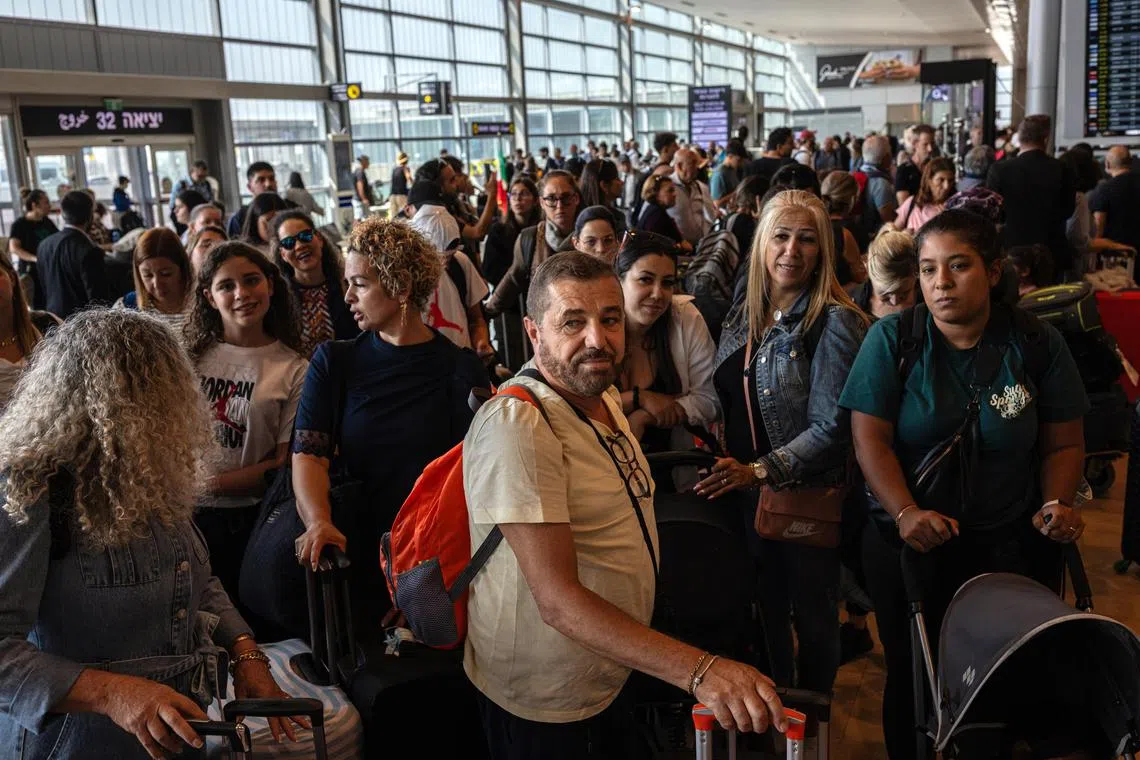 Stranded travellers wait to be booked on flights at Ben Gurion International Airport, outside Tel Aviv.