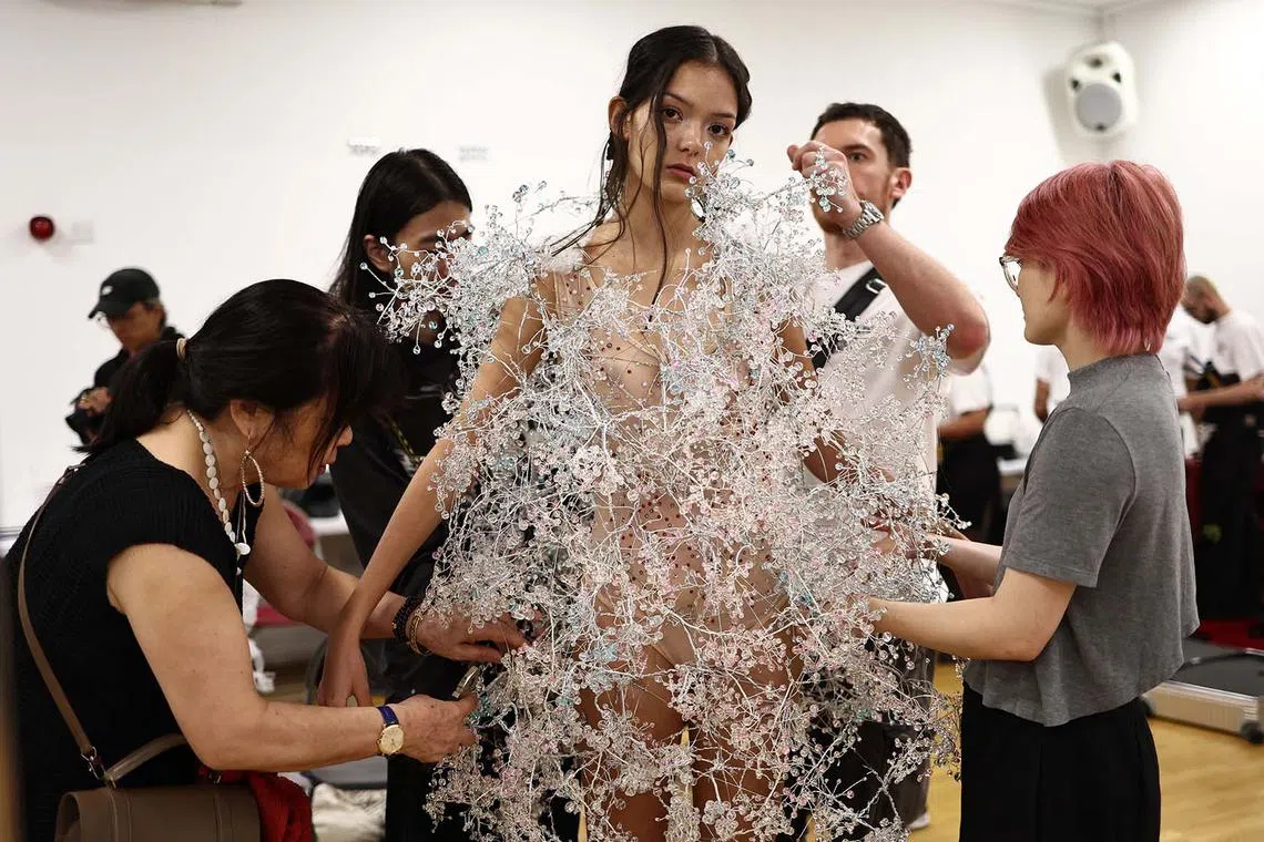Final preparations are made on a model backstage ahead of a catwalk presentation for designer Susan Fang's Spring/Summer 2024 collection, at London Fashion Week in London, on Sept 17.