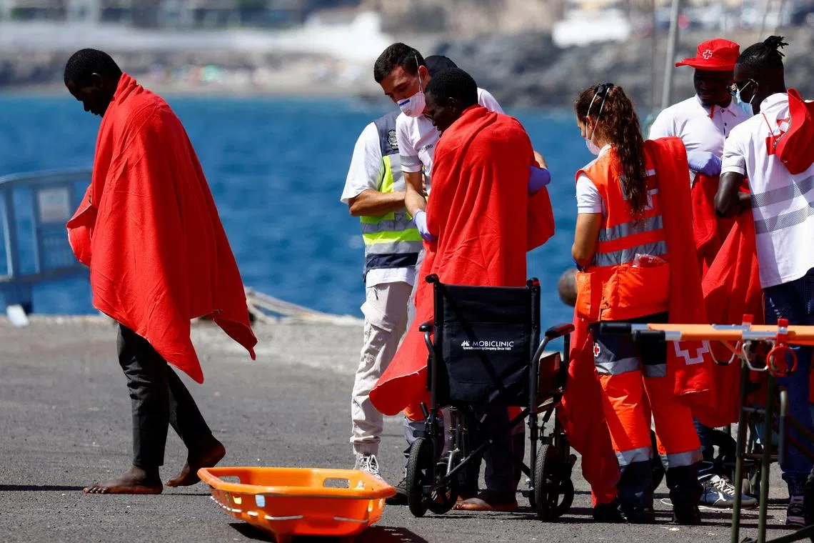 Migrants are treated by Red Cross volunteers after disembarking from a Spanish coast guard vessel at the port of Arguineguin, on the island of Gran Canaria, Spain, August 28, 2024. REUTERS/Borja Suarez/File Photo