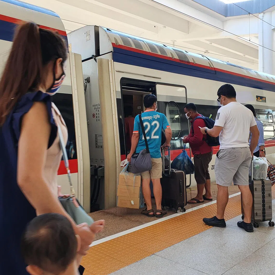 Passengers boarding the Laos-China Railway train at Vientiane station. 