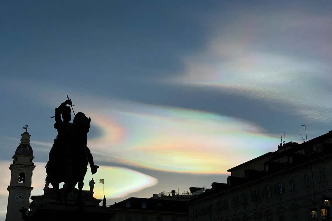 Rare nacreous clouds, known as rainbow clouds, are seen from Piazza San Carlo square in Turin, Italy, Dec 22, 2023.