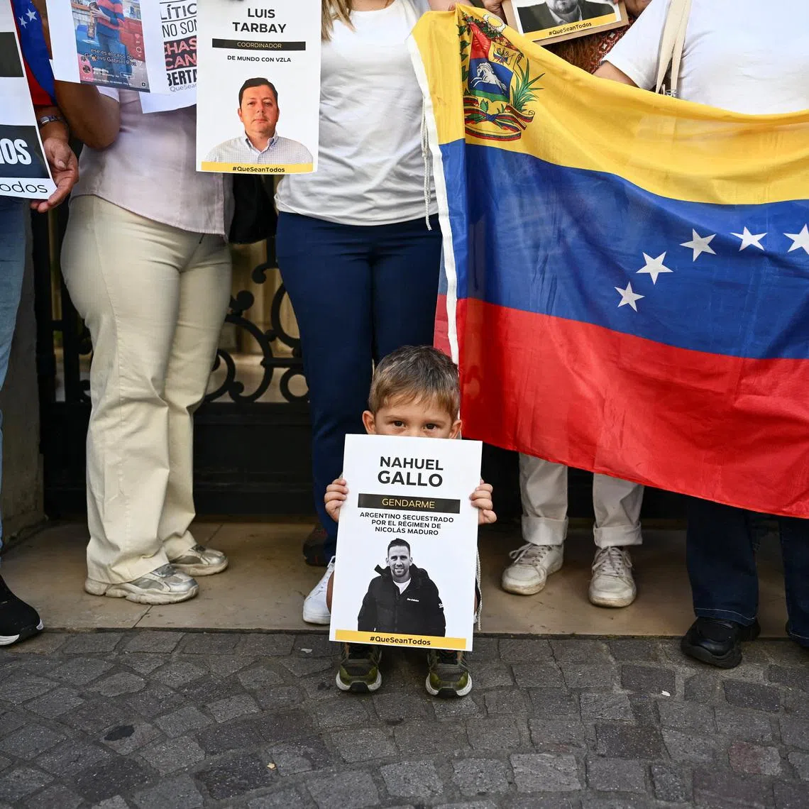 Victor, son of Argentine Gendarmerie officer Nahuel Gallo, detained in Venezuela, holds a poster as he stands with relatives outside the Apostolic Nunciature along with activists to ask the Vatican to press Venezuelan authorities for the detainees' release, in Buenos Aires, Argentina, January 23, 2026. REUTERS/Pedro Lazaro Fernandez