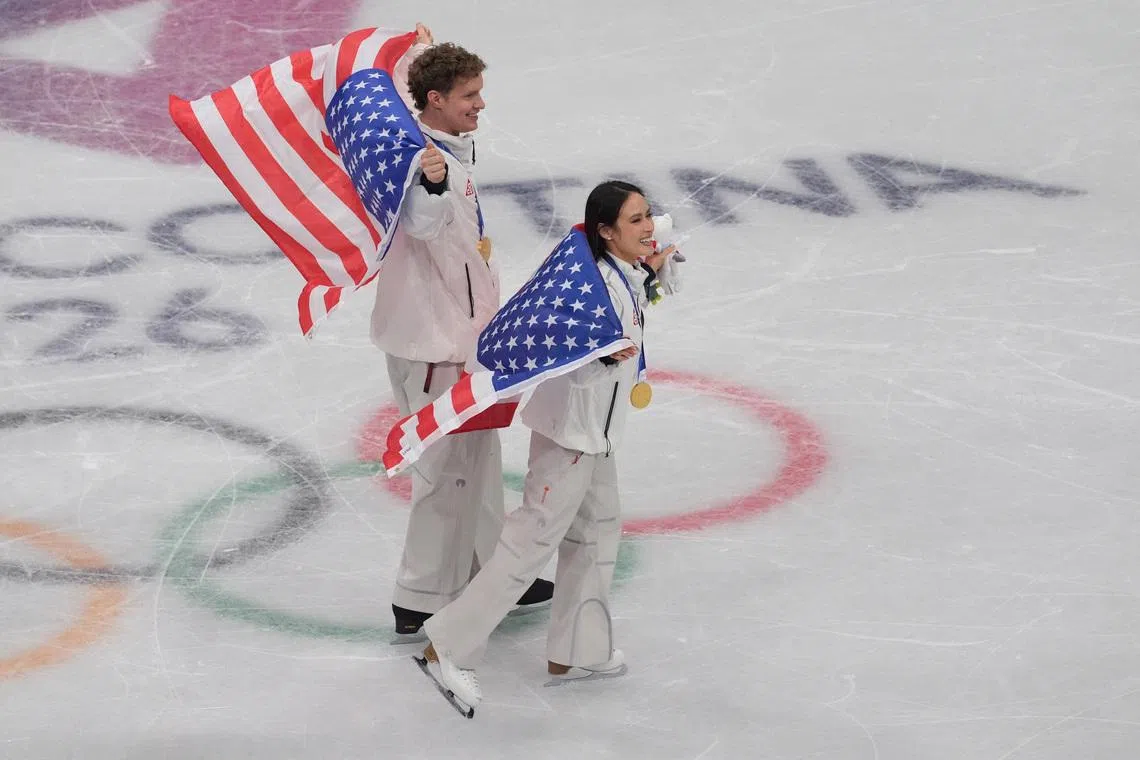 Feb 8, 2026; Milan, Italy; Ellie Kam and Danny O'Shea of the United States of America celebrate after winning gold in the figure skating team event during the Milano Cortina 2026 Olympic Winter Games at Milano Ice Skating Arena. Mandatory Credit: Amber Searls-Imagn Images