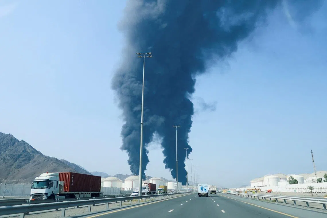 Smoke rises in the Fujairah oil industry zone, caused by debris after interception of a drone by air defenses, according to the Fujairah media office, amid the U.S.-Israel conflict with Iran, in Fujairah, United Arab Emirates, March 14, 2026. REUTERS/Staff