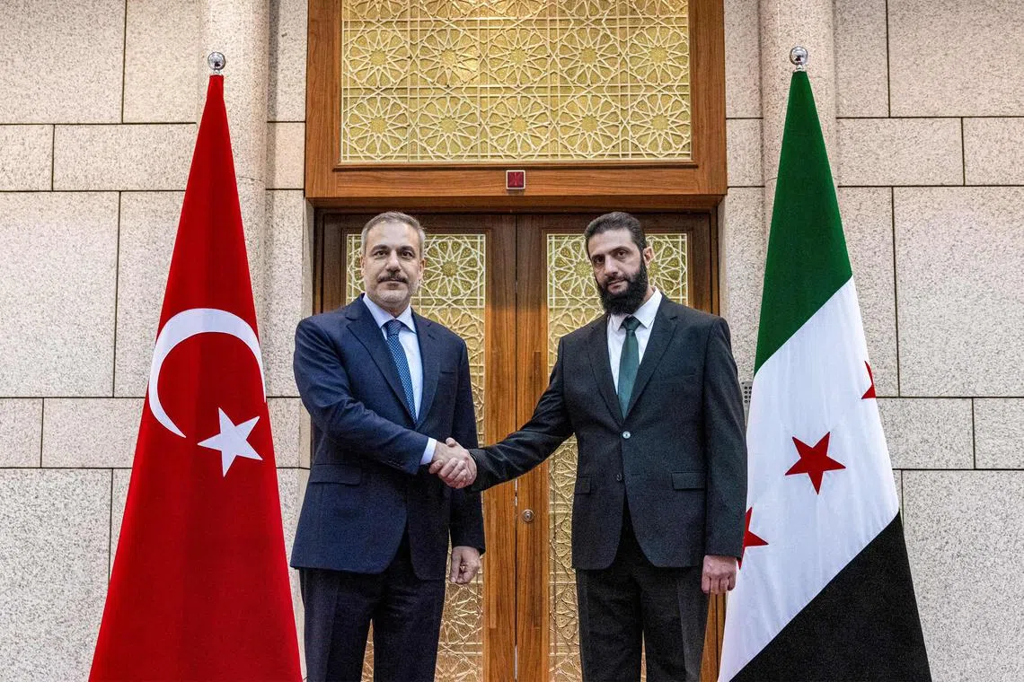 Turkey's Foreign Minister Hakan Fidan (left) being received by Syria’s new leader, Mr Ahmed al-Sharaa, in Damascus.