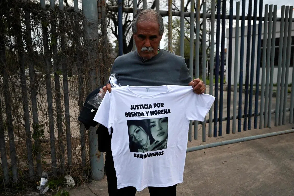 Mr Antonio Del Castillo, grandfather of two of the victims, holding up a shirt with their images. The murder of three women had been livestreamed on Instagram, with the crime linked to narco activity.