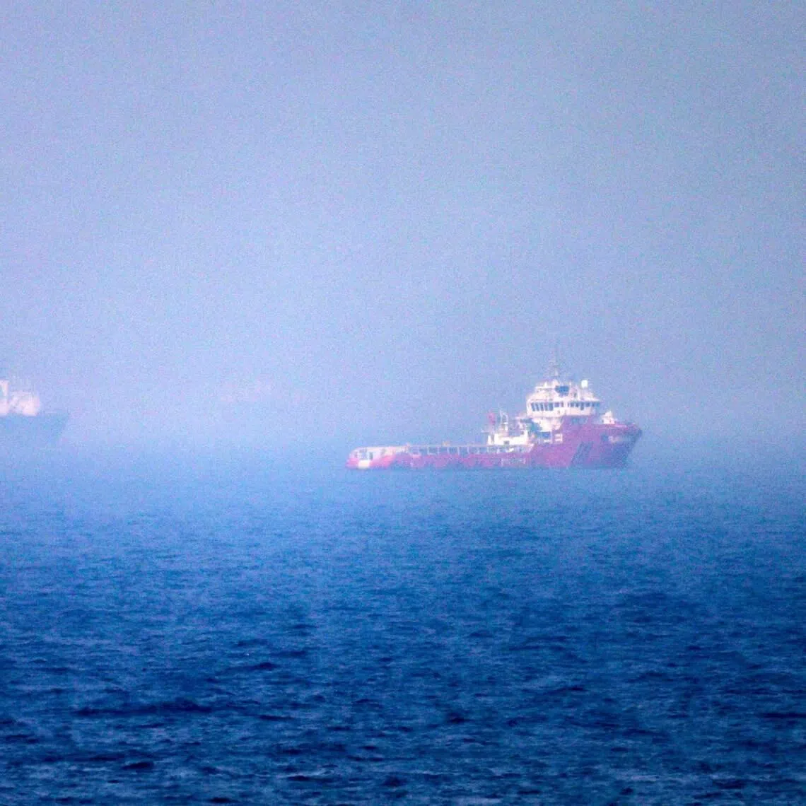 Ships sail near the Strait of Hormuz off the eastern coast of the United Arab Emirates on July 13.