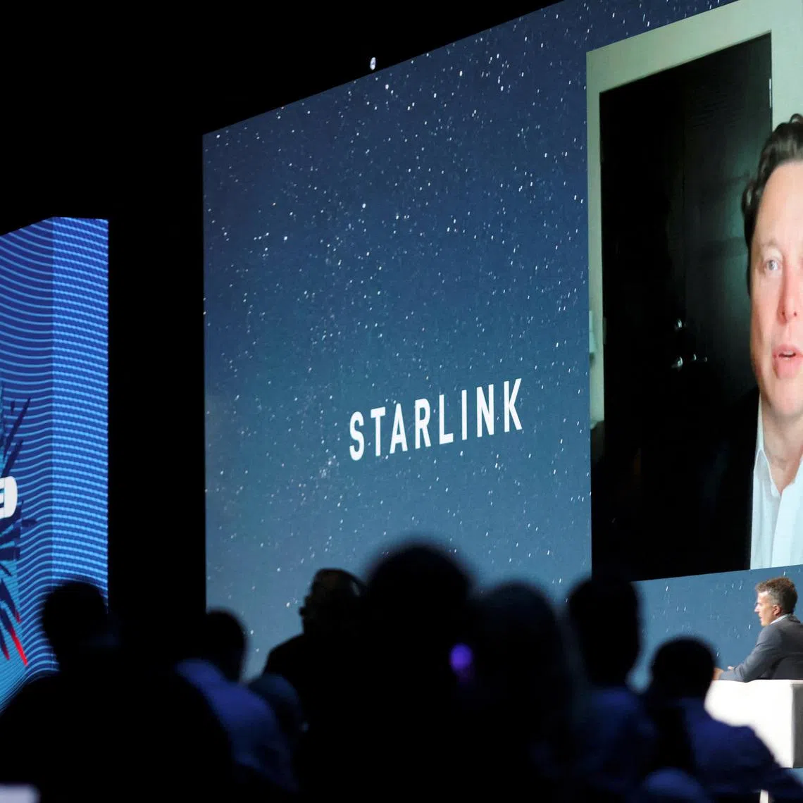 FILE PHOTO: SpaceX founder and Tesla CEO Elon Musk speaks on a screen during the Mobile World Congress (MWC) in Barcelona, Spain, June 29, 2021. REUTERS/Nacho Doce/File Photo