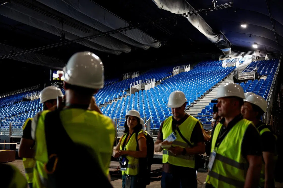 Journalists visit the Champ de Mars Arena where judo and wrestling events will be held during the Paris 2024 Olympic Games, at the foot of the Eiffel Tower, on June 25.