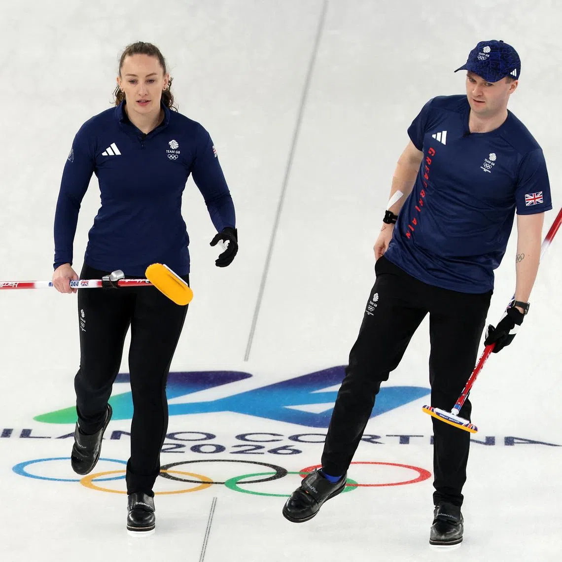 Milano Cortina 2026 Olympics - Curling - Mixed Doubles Round Robin Session 7 - Britain vs Canada - Cortina Curling Olympic Stadium, Cortina d'Ampezzo, Italy - February 07, 2026. Bruce Mouat of Britain and Jennifer Dodds of Britain after winning against Brett Gallant of Canada and Jocelyn Peterman of Canada REUTERS/Issei Kato