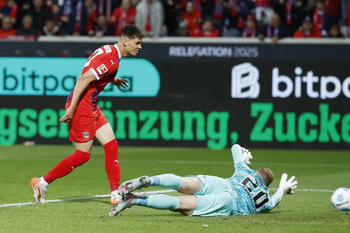 Soccer Football - Bundesliga - Bundesliga - Relegation Playoff - First Leg - 1. FC Heidenheim v SV Elversberg - Voith-Arena, Heidenheim, Germany - May 22, 2025 1. FC Heidenheim's Mathias Honsak scores their second goal REUTERS/Heiko Becker