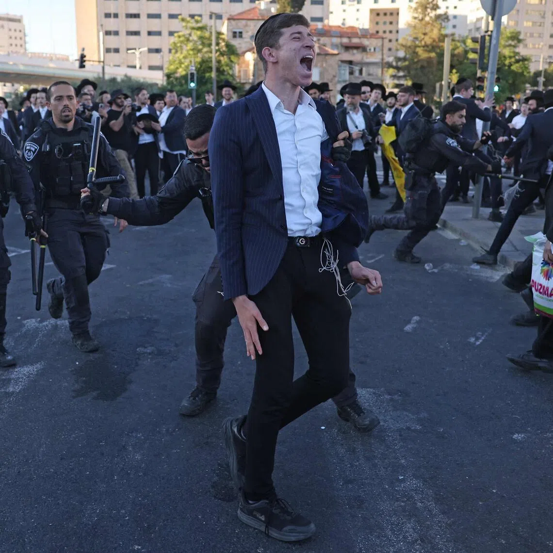 Israeli police disperse ultra-Orthodox Jews protesting against conscription by blocking the entrance to Jerusalem, on June 1.