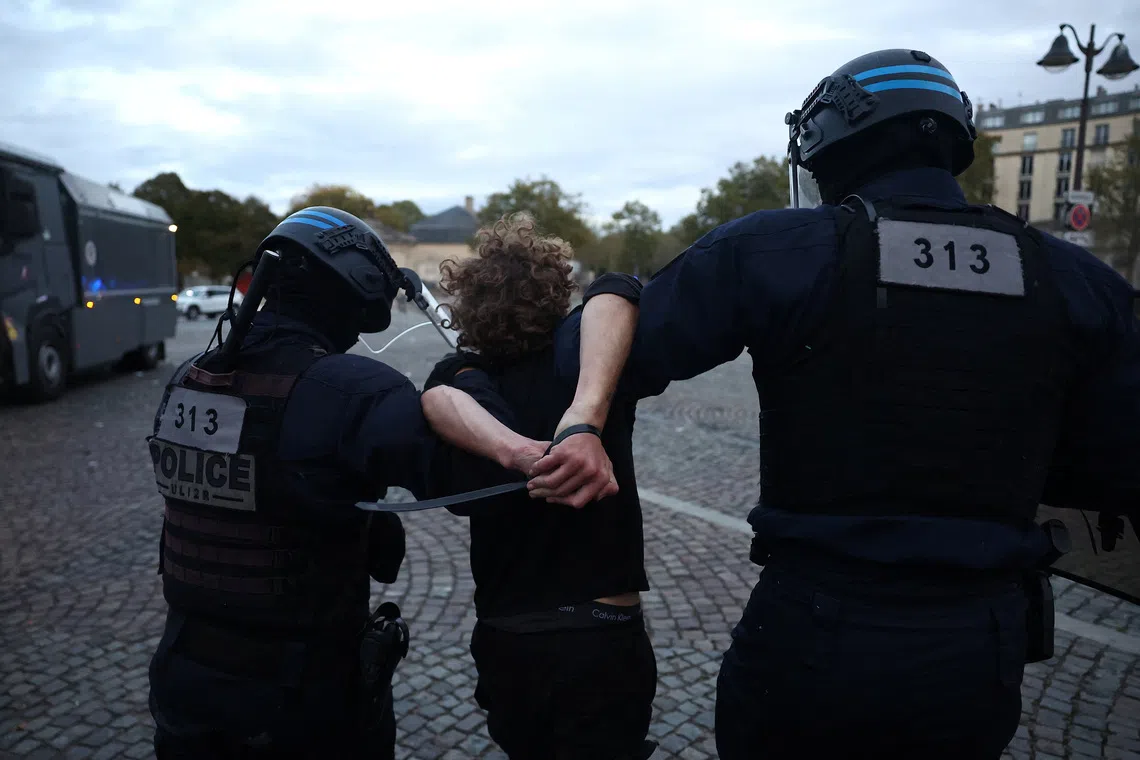French police apprehend a protester amid clashes during a demonstration by French high school and university students in Paris as part of a nationwide protest movement led by students, supported by teachers, school parents and labour unions, demanding better school conditions and concrete measures, France, October 13, 2026.   REUTERS/Abdul Saboor