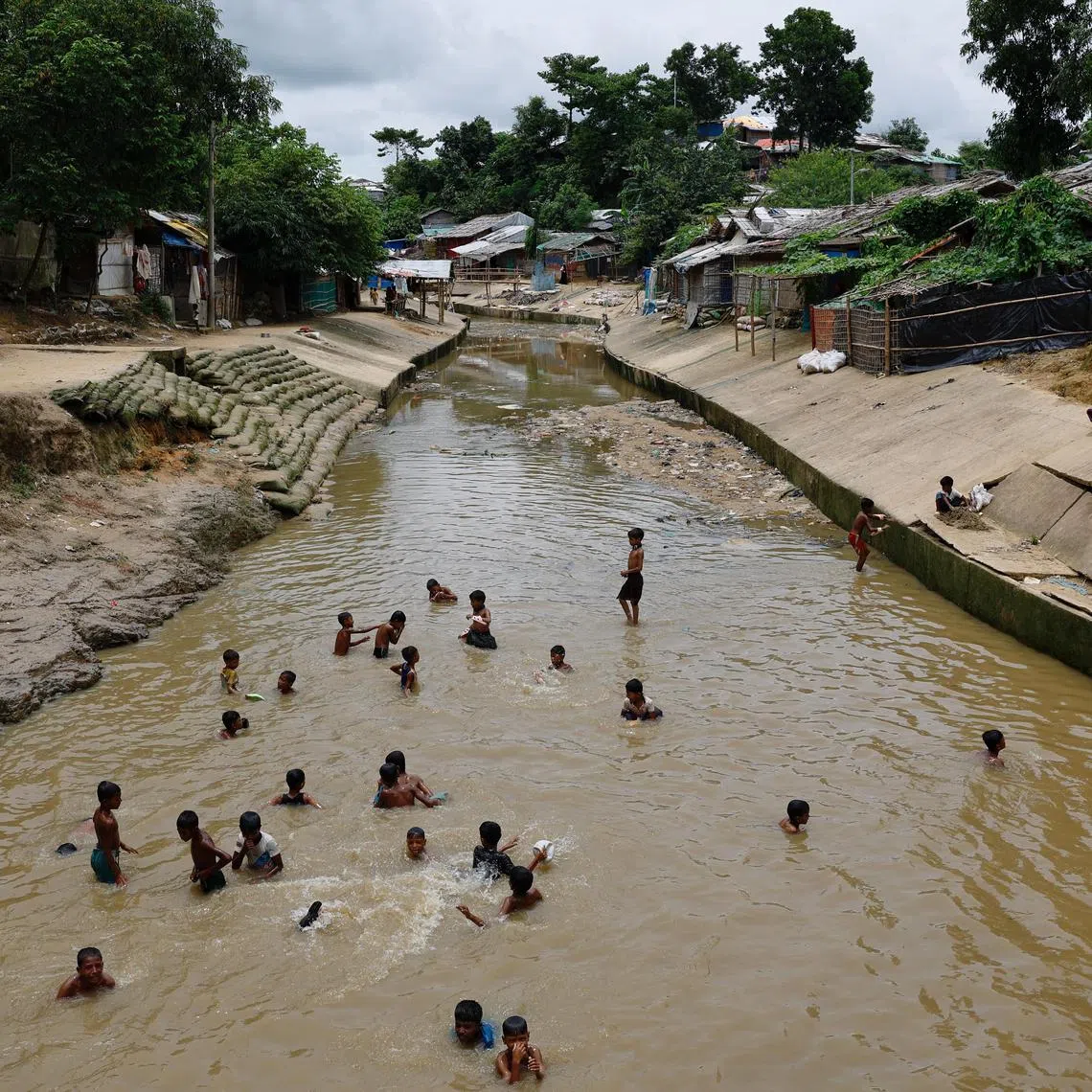 Rohingya refugee children bathing in a stream at the Kutupalang refugee camp in Cox's Bazar, Bangladesh, on June 26. A UN fact-finding mission concluded that a 2017 military campaign by Myanmar that drove 730,000 Rohingya into Bangladesh had included “genocidal acts”.