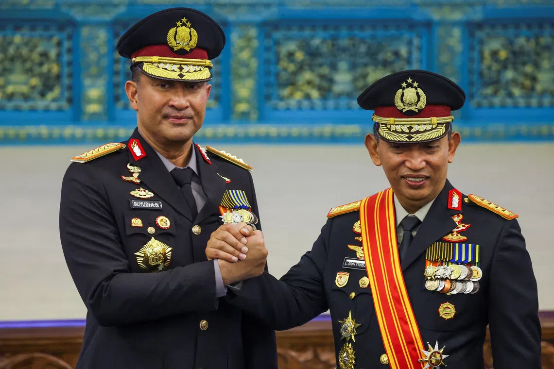 Indonesia’s newly appointed National Police Chief Suyudi Ario Seto (left) shakes hands with newly appointed Presidential Chief of Staff Listyo Sigit Prabowo.