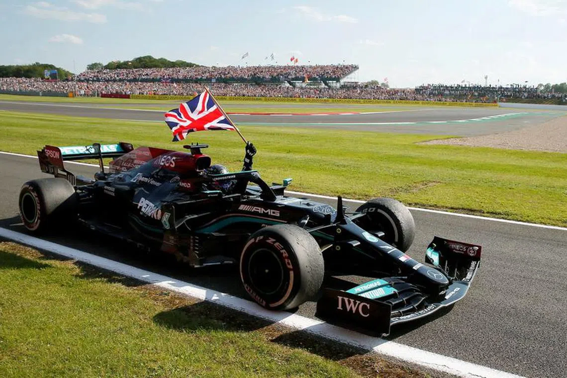FILE PHOTO: Formula One F1 - British Grand Prix - Silverstone Circuit, Silverstone, Britain - July 18, 2021 Mercedes' Lewis Hamilton celebrates after winning the race REUTERS/Andrew Couldridge/File Photo