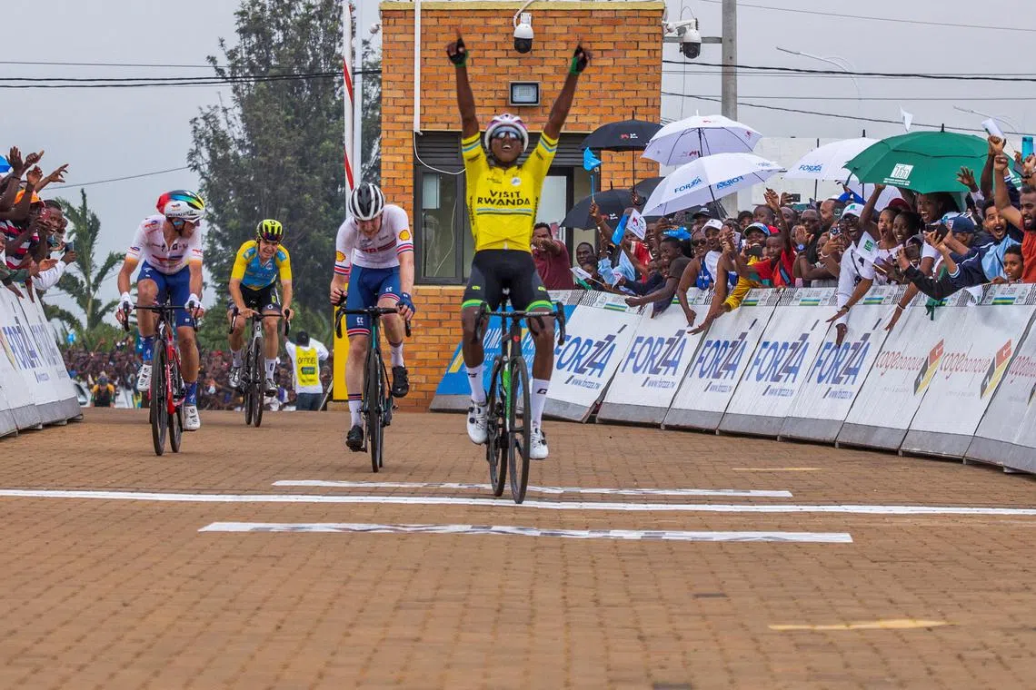 FILE PHOTO: Eritrean cyclist Henok Mulueberhane celebrates winning the 2023 Tour du Rwanda at the final stage of the race at the Canal Olympia Rebero, in Kigali, Rwanda February 26, 2023. REUTERS/Jean Bizimana/File Photo